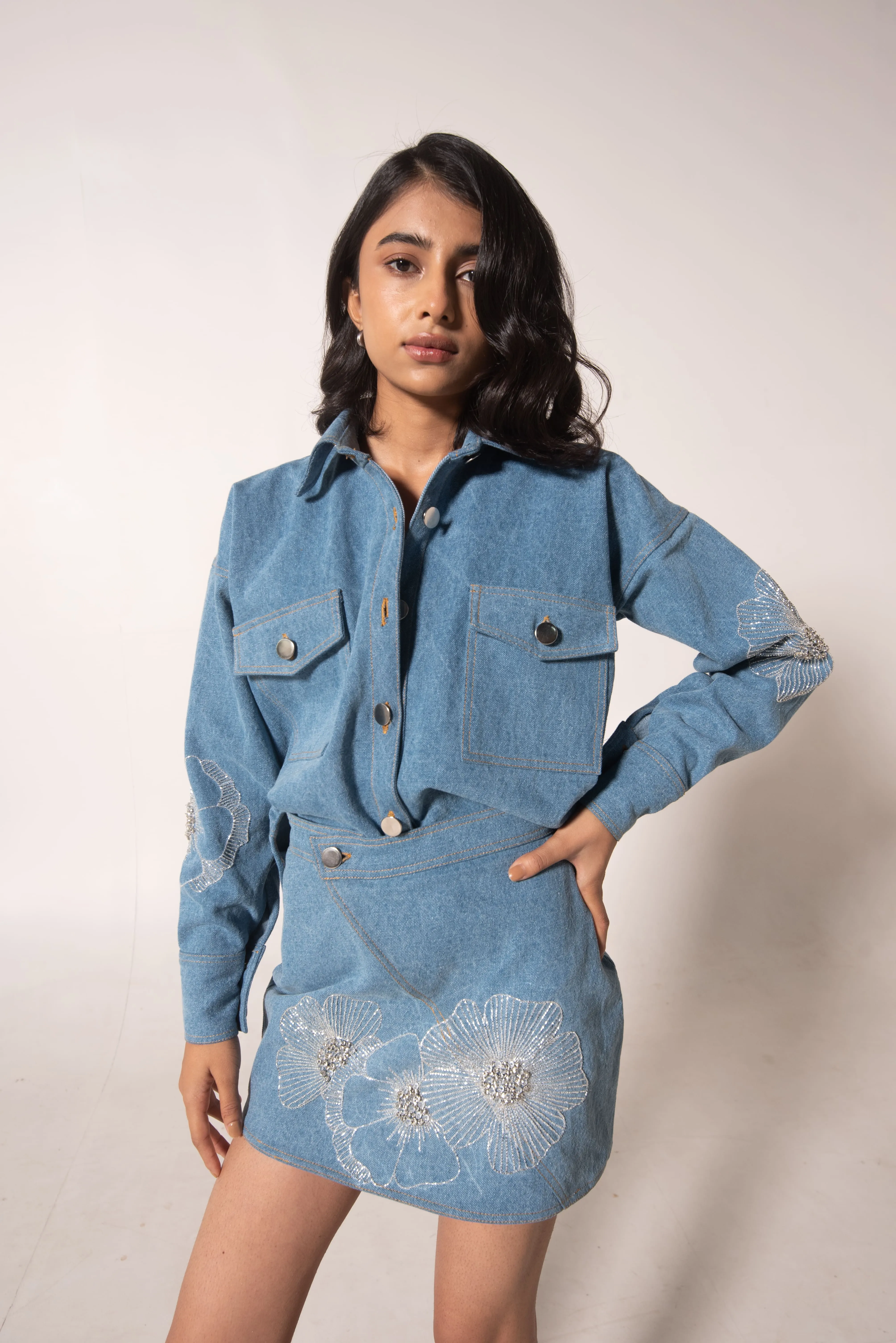 Denim mini skirt with floral embellishments